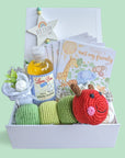 Lovely gift for a new baby. Includes an organic colourful caterpillar, beautifully illustrated baby milestone cards, star hanging plaque, baby socks, mittens and baby organic wash.