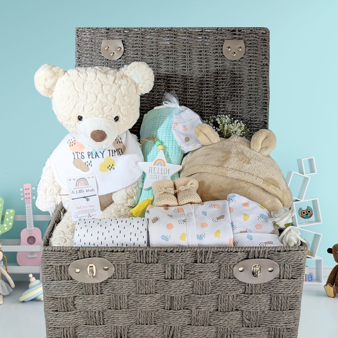Large teddy bear baby basket with cuddly teddy bear, baby bath robe, muslin squares, baby booties and also a gift for mum. Presented in an eco rope basket.