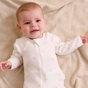 Newborn wearing vanilla bear welcome baby organic clothing set made from soft organic cotton