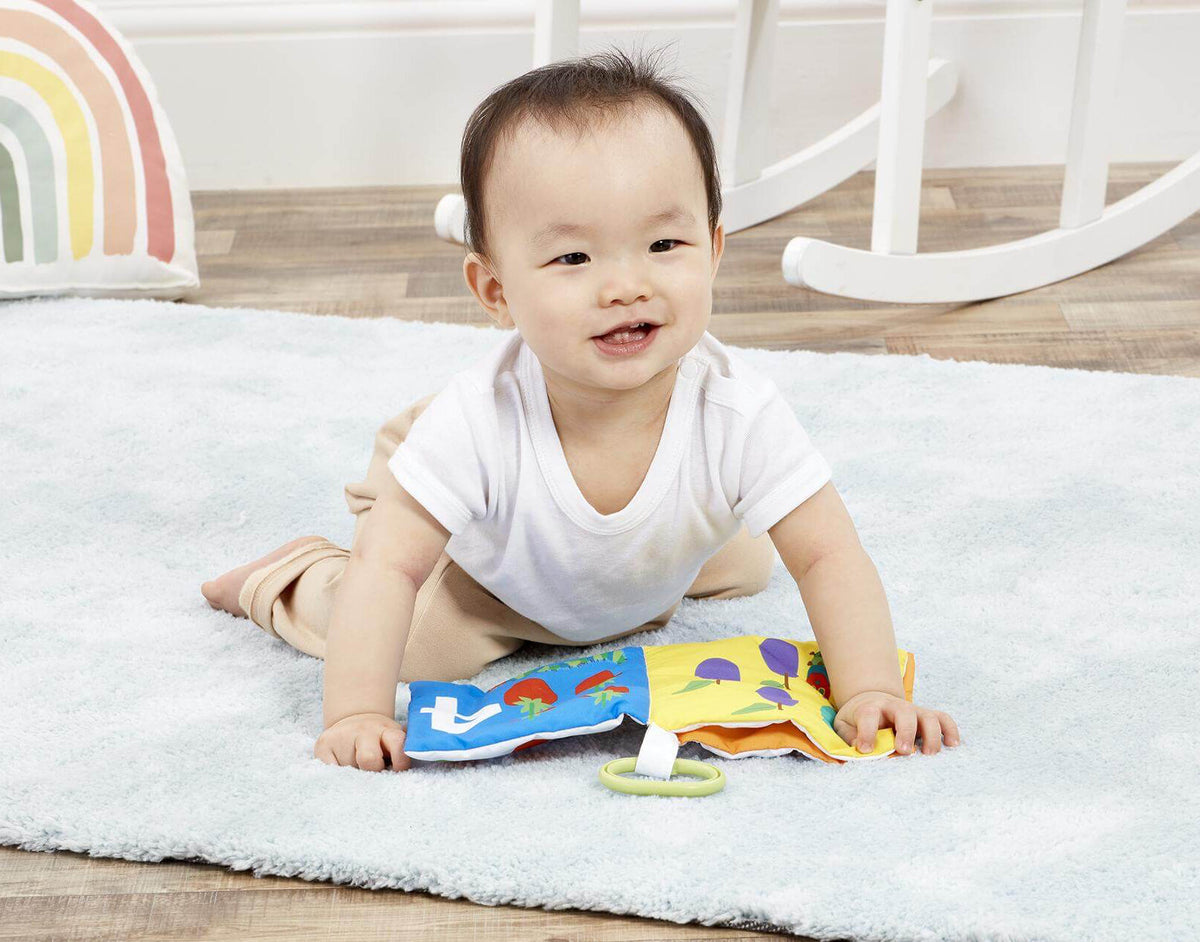 Baby playing with The Very Hungry Caterpillar Counting Soft Book