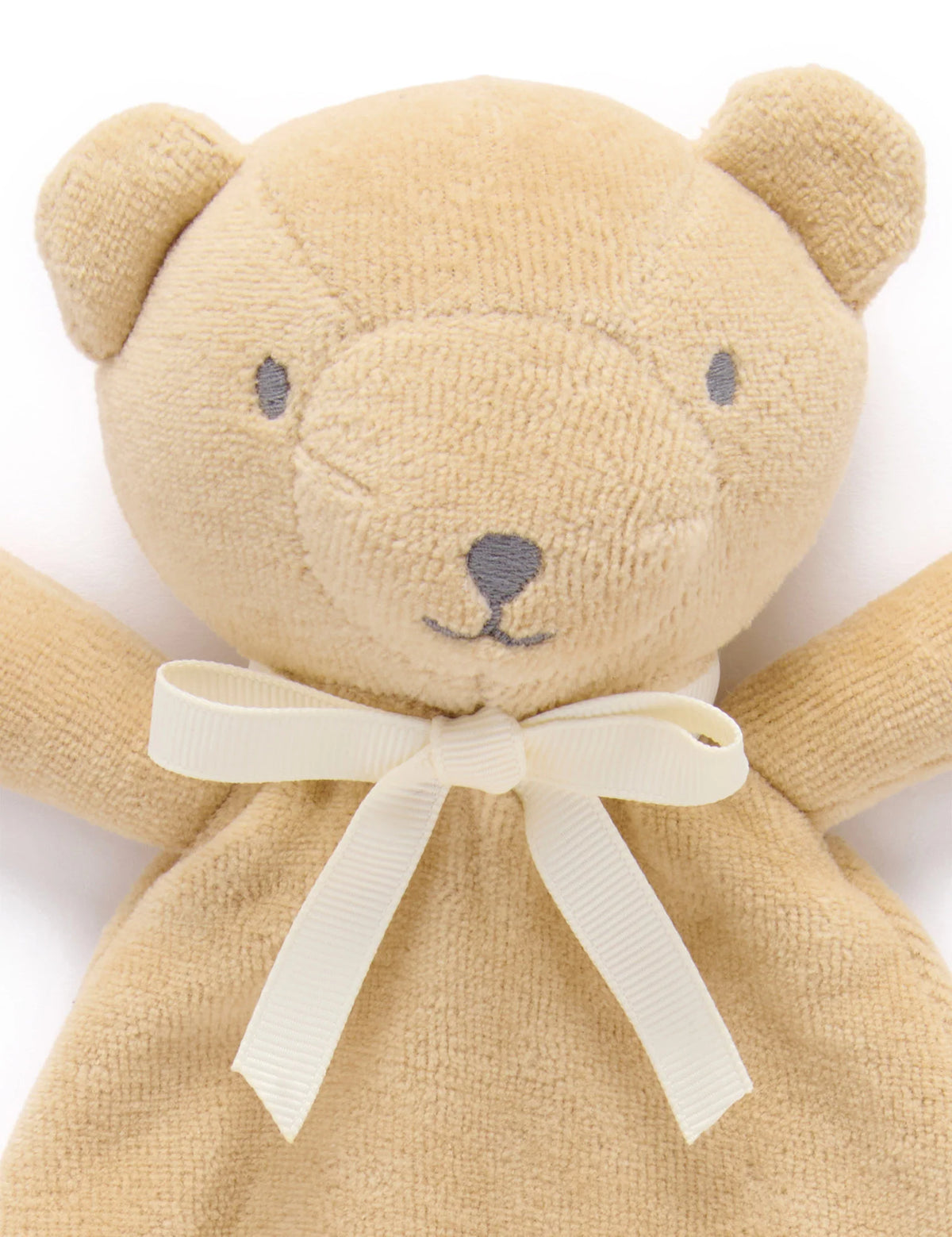 Close-up of the wheat bear comforter's face and cream ribbon bow