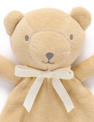 Close-up of the wheat bear comforter's face and cream ribbon bow