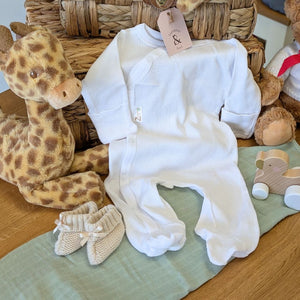 White baby sleepsuit in soft cotton and made from recycled materials.