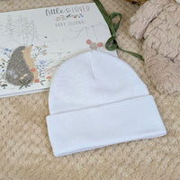 White cotton beanie baby hat.