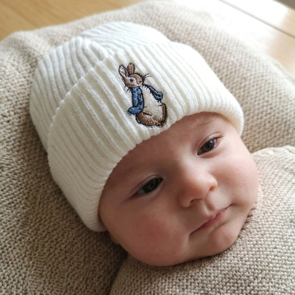 White knitted baby hat with blue embroidered bunny for newborn to 3 months