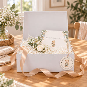 A white magnetic gift box filled with white shredded paper 