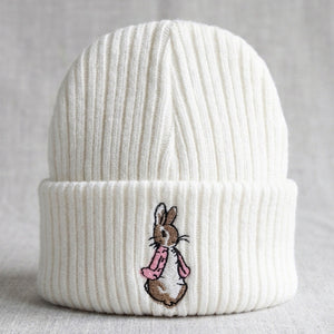 White knitted baby hat with pink embroidered bunny detail for newborns 0-3 months