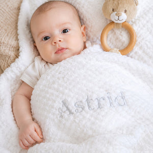 Personalised baby gift, white waffle baby blanket embroidered with the name 'Astrid'