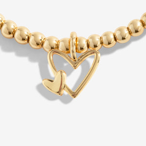 Close-up of the double heart charm on the Wonderful Mum gold Bracelet

