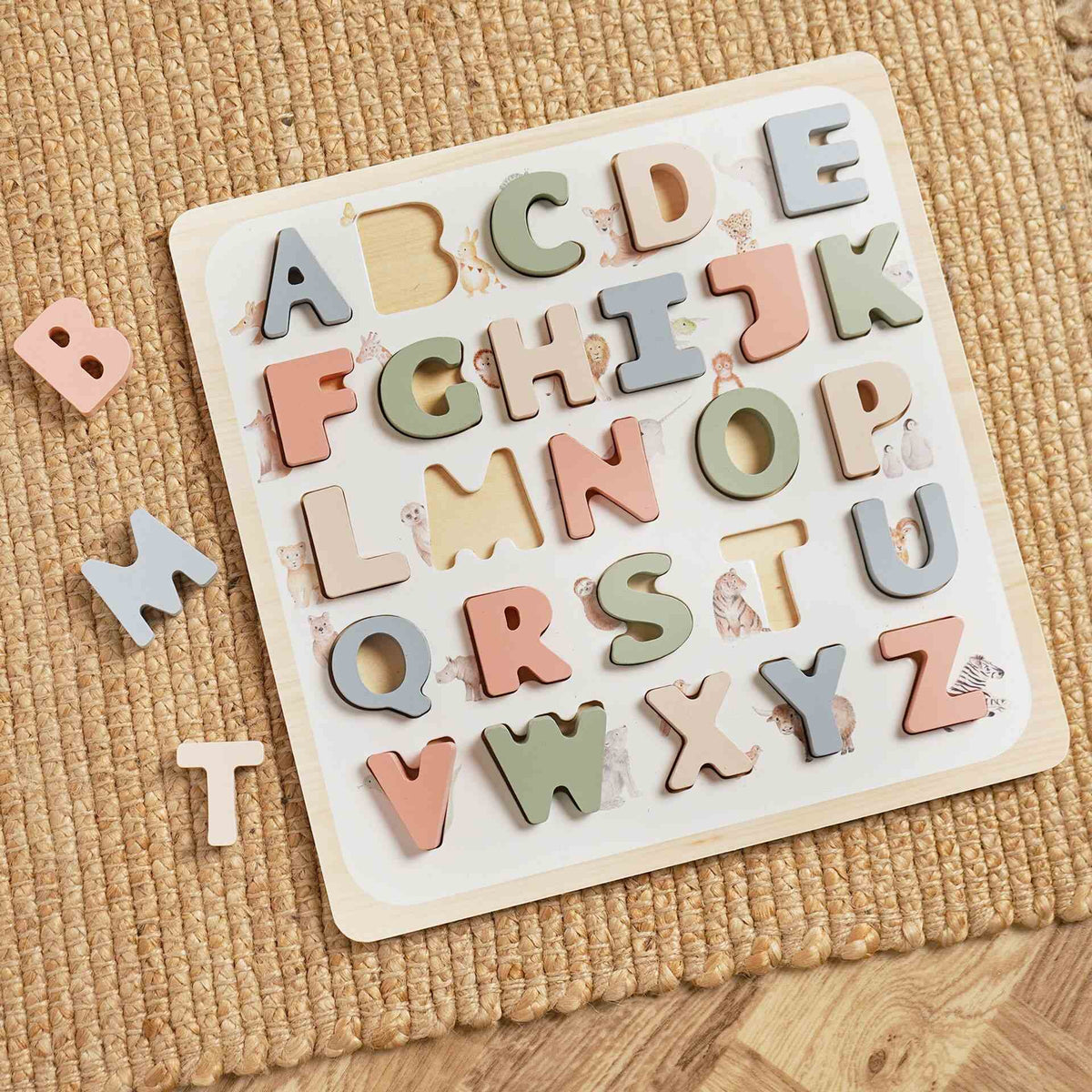 Wooden alphabet matching board with pastel A–Z letters and B, M and T pieces beside it