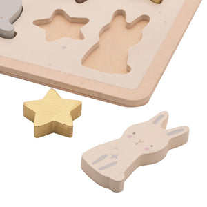 Wooden animal puzzle baby toy with teddy, bunny, moon and star shapes on a soft neutral wooden board