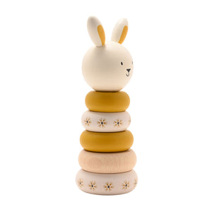 Side view of the wooden bunny stacker showing ochre, cream and natural wood rings.