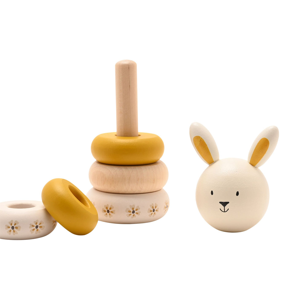 Wooden stacking rings partly assembled on the post, with a bunny head and loose rings beside it.