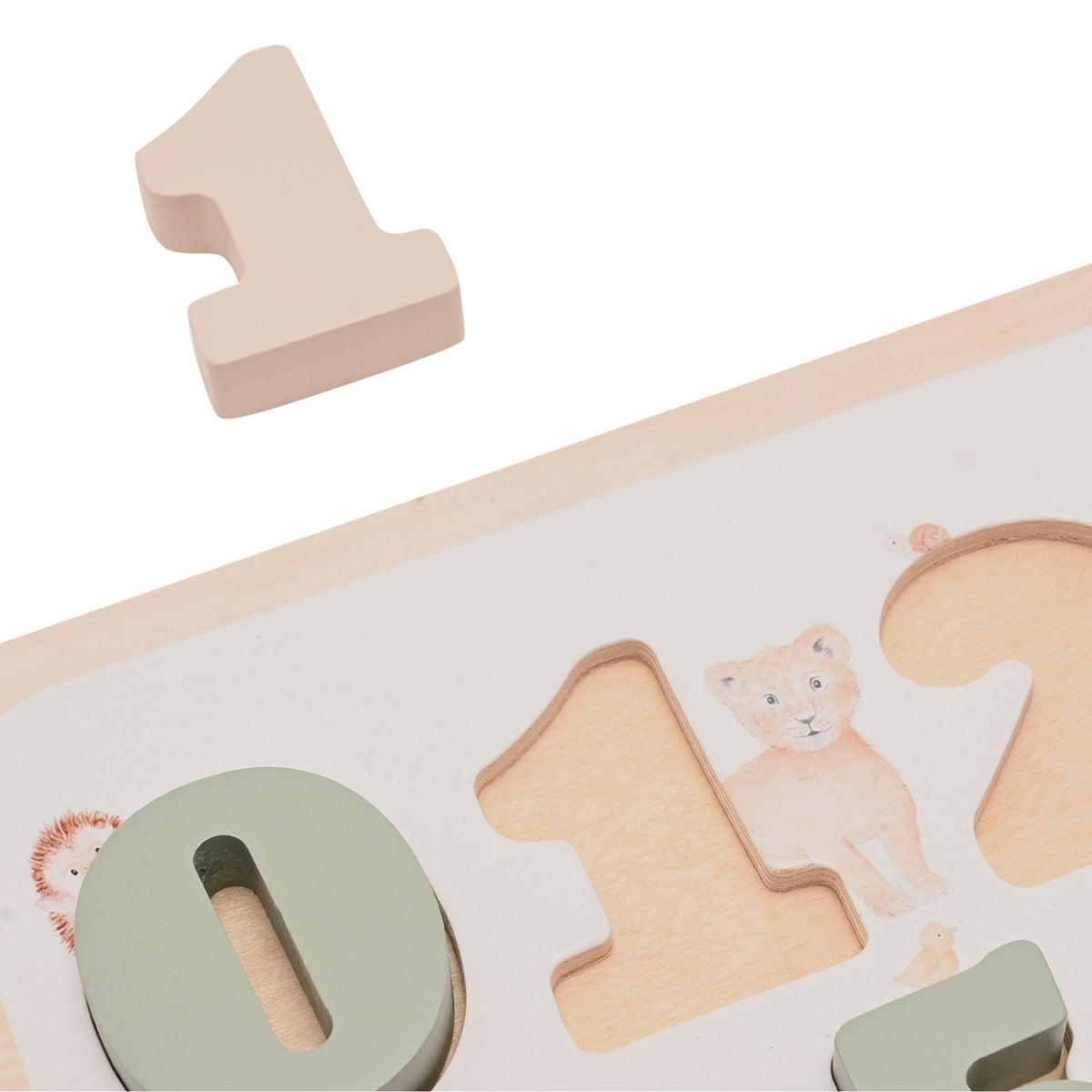 Close-up of the wooden number one lifted above its matching recess, beside the green zero piece.