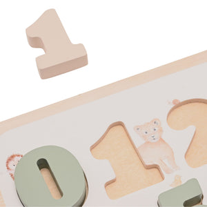 Close-up of the wooden number one lifted above its matching recess, beside the green zero piece.
