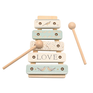 Overhead view of five wooden xylophone bars with two mallets arranged diagonally