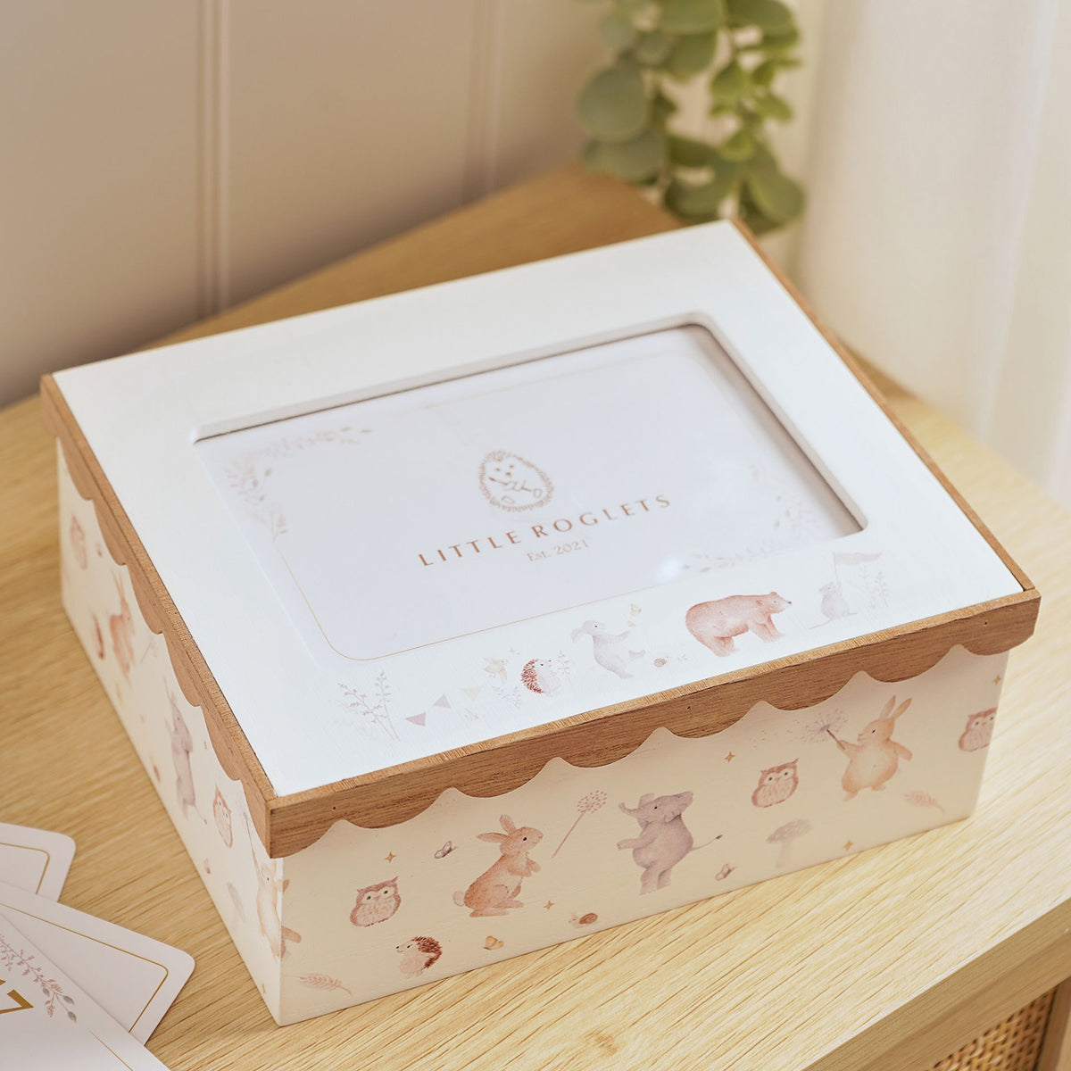 Woodland photo keepsake box on a wooden surface, with its closed photo lid and illustrated animal sides.