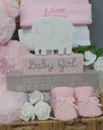 Baby girl gift hamper basket with teddy and other gifts.