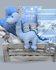 Baby boy hamper gifts with blue dinosaur toy, blanket, baby hat & congratulations chocolates in a wooden box.