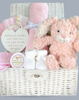 Beautiful new baby girl gift basket with cuddly bunny, soft blanket, muslin wraps and bunny soft toy. Presented in a hamper basket keepsake box.