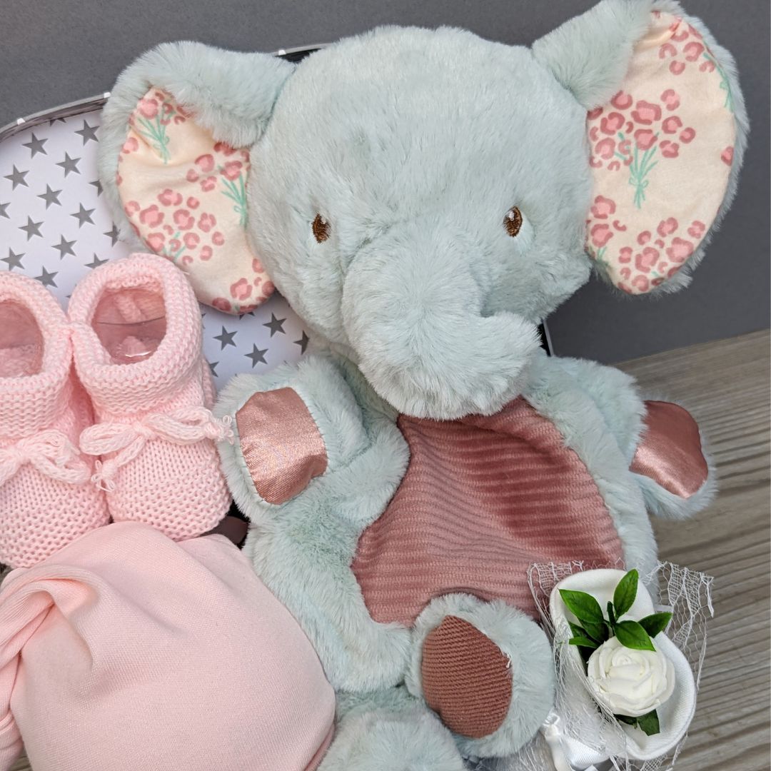 Adorable New Baby Girl Gift. Contains Pink Baby Girl Booties. New Parents Chocolates. Baby Hat. Baby Mittens. Stunning Elephant. Keepsake Luggage Trunk 