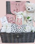 Stunning new baby girl gift. Presented in a hamper basket with organic clothing, teddy bear, muslin wrap, mittens and mug for mummy.