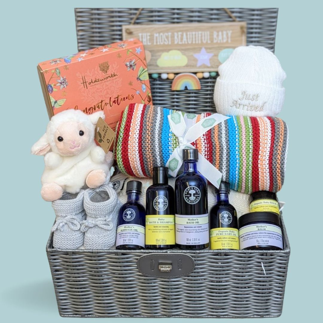New mum hamper gift with skincare, blanket,  chocolates, lamb soft toy and baby hat.