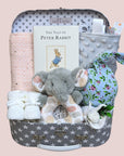 Baby girl gift box with peter rabbit book, muslin wrap, baby booties, taggie blanket and baby hat.
