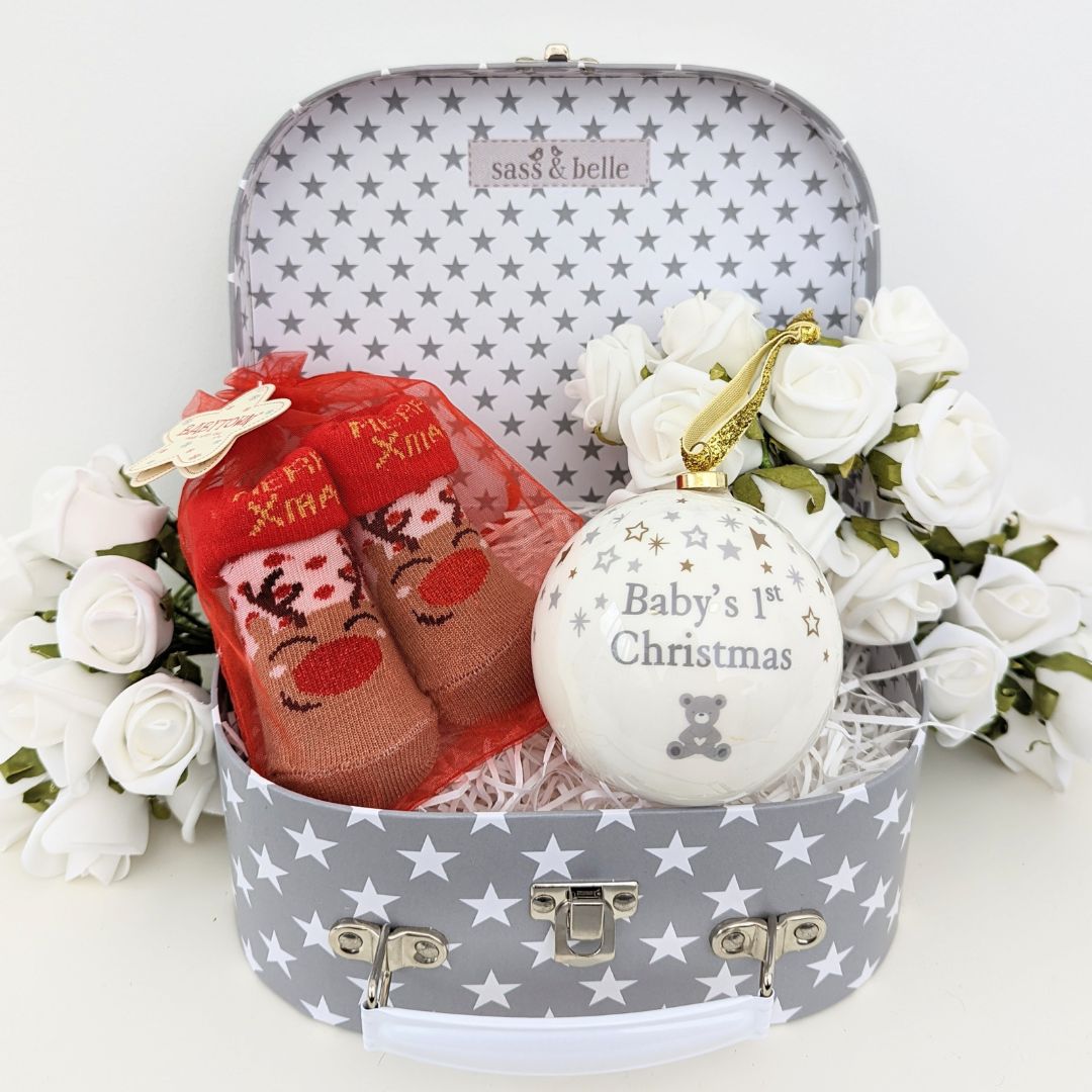 Baby&#39;s first Christmas hamper gift with bauble and baby socks.