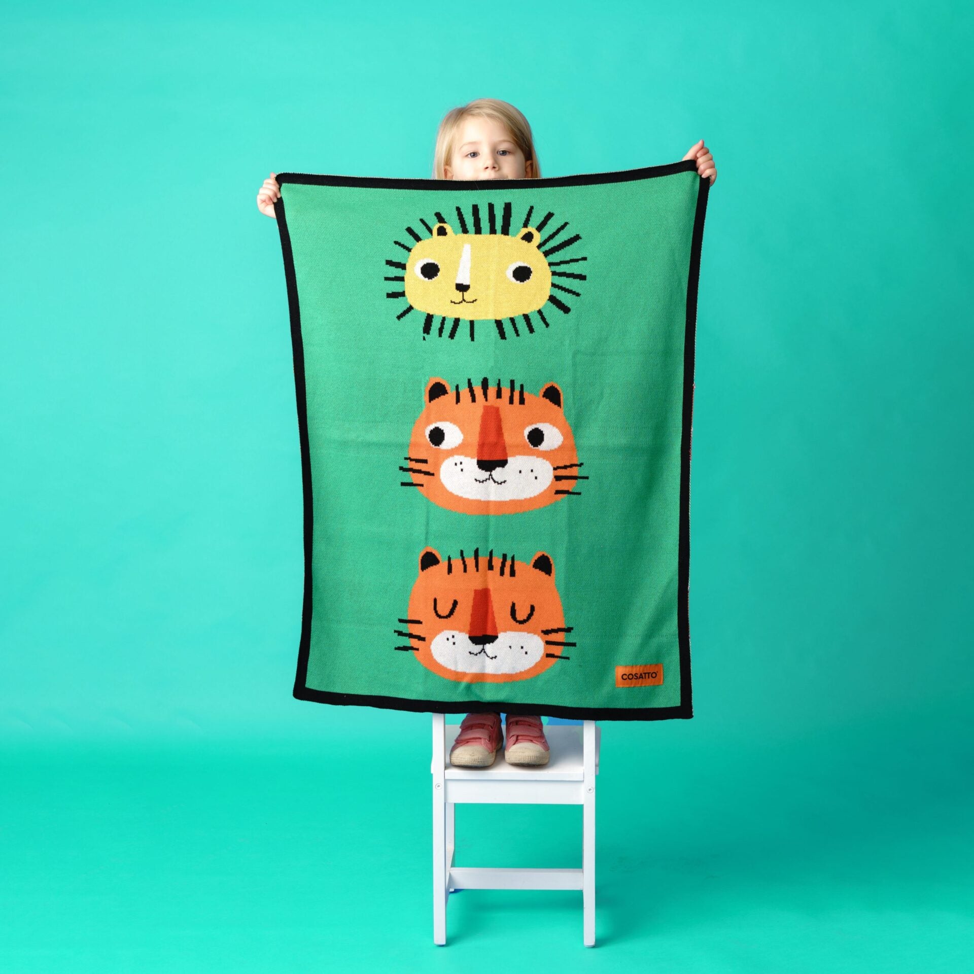 Green cotton blanket with three large tiger faces for children and babies.