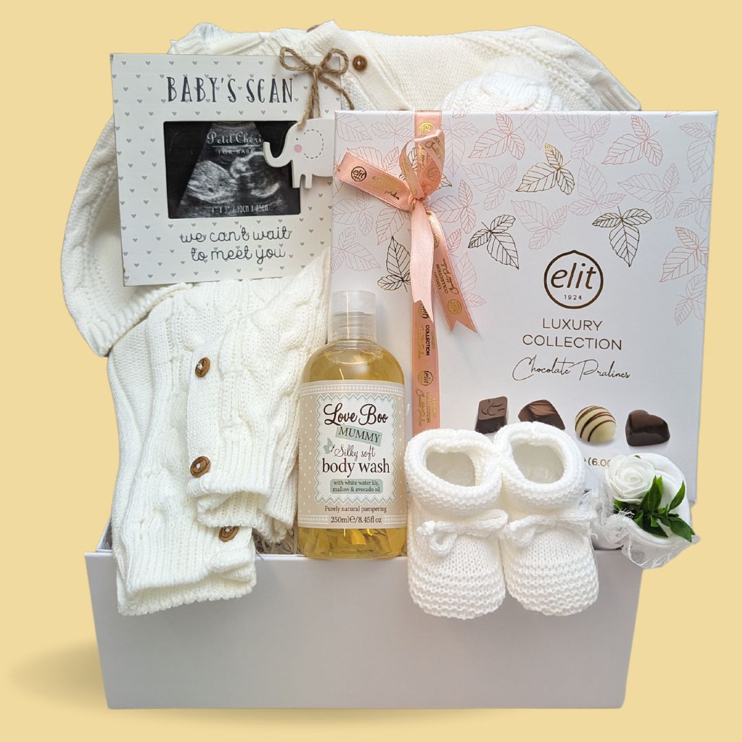 mum-to-be hamper gift with chocolates, body wash, baby scan, knit baby romper and knit baby booties. 