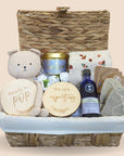 mum to be hamper basket with mothers massage oil, relaxation candle, organic tea, pregnancy discs, teddy bear, mittens and muslin swaddle.