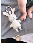White bunny musical pull down toy to keep baby amused whilst in a car seat or pram.