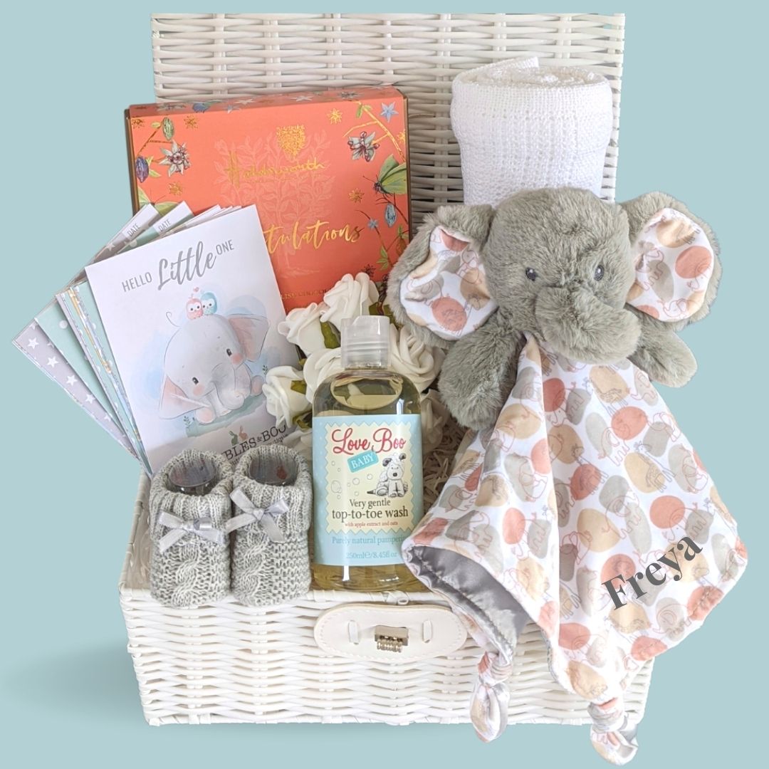 New baby hamper basket. Wicker effect hamper keepsake. Includes chocolates for the new parents, personalisable elephant, baby blanket, baby booties.