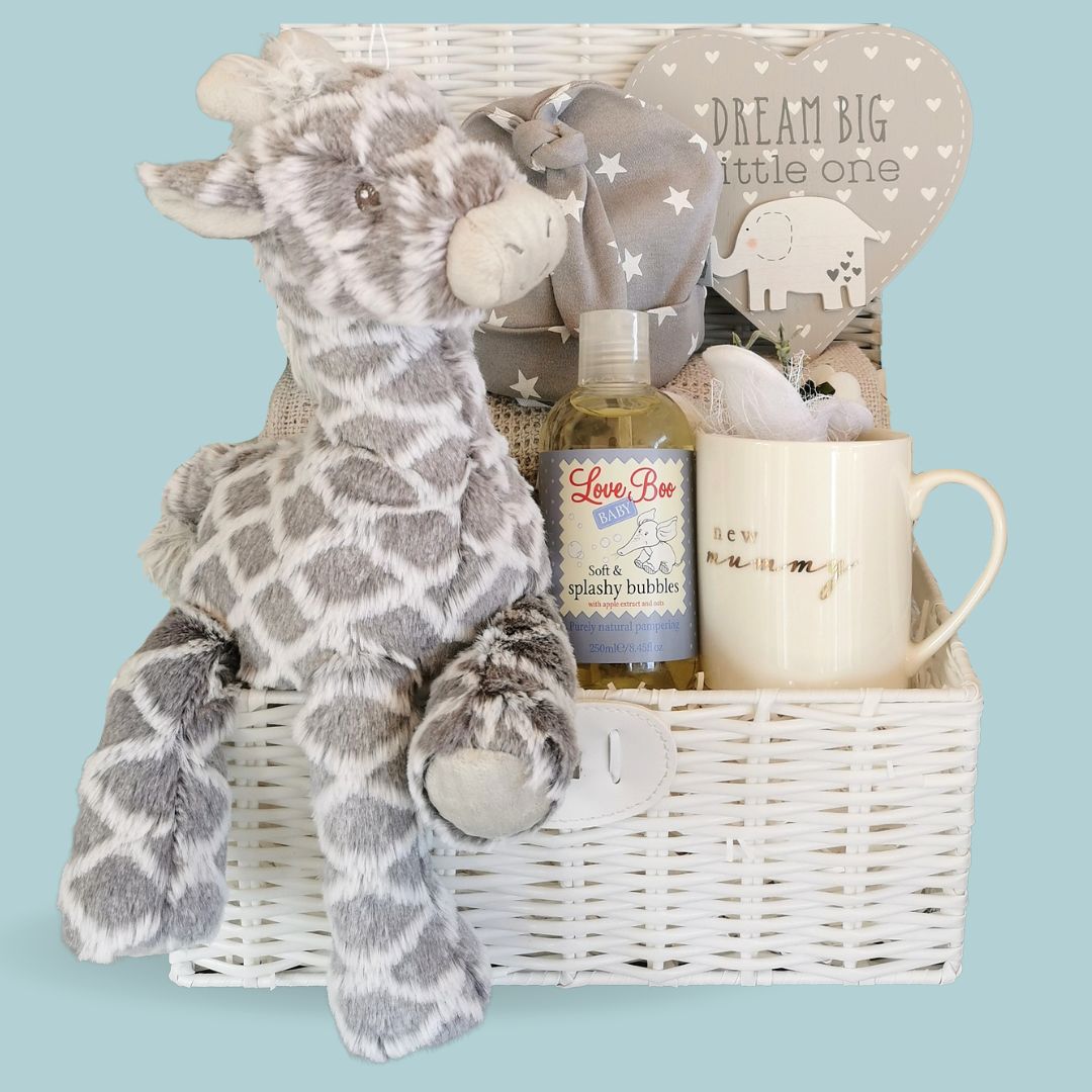 New mum gift hamper filled with presents in a wicker basket with china mummy mug.