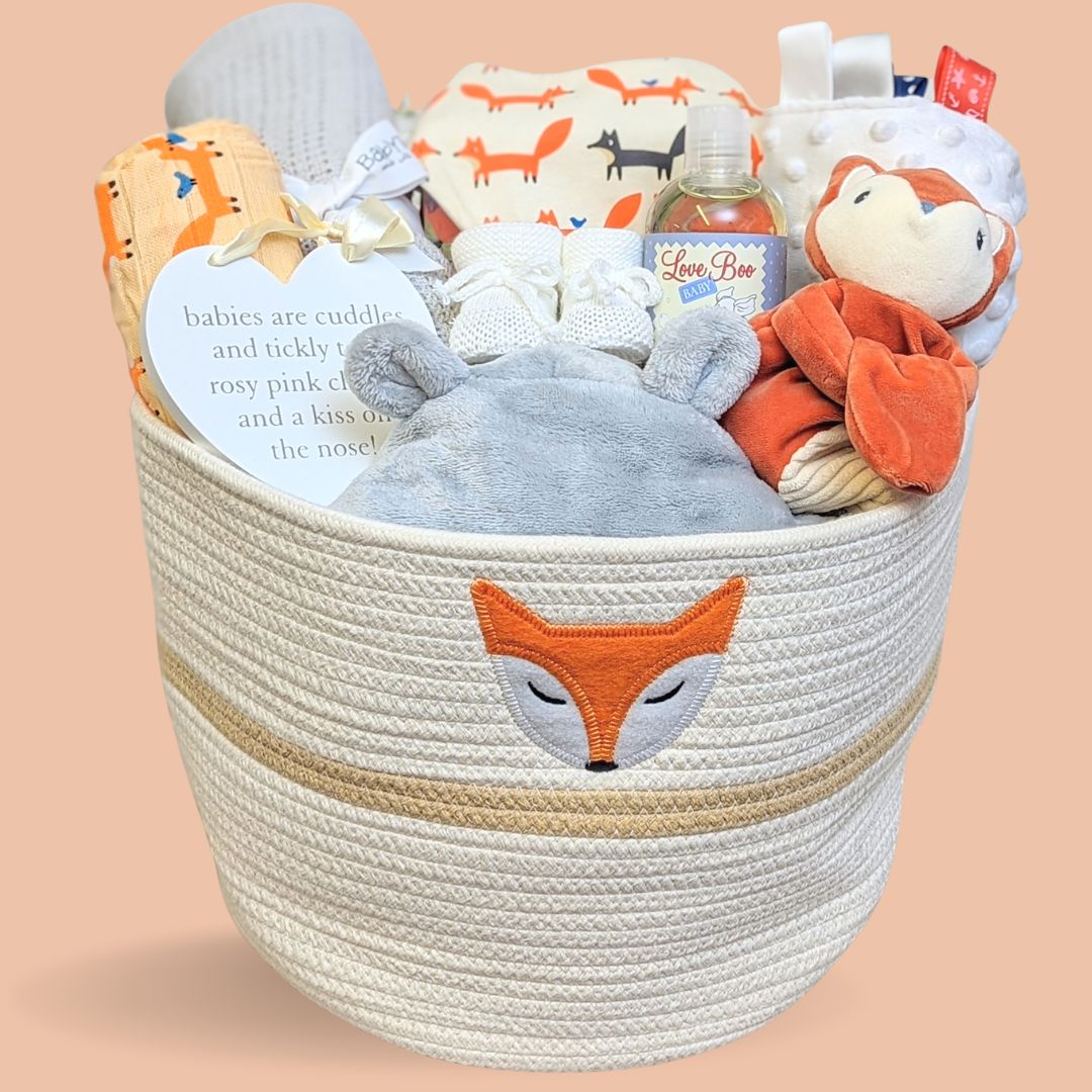 Baby hamper basket with woodland theme. Includes fox comforter, bath robe, blanket, muslin and baby booties.