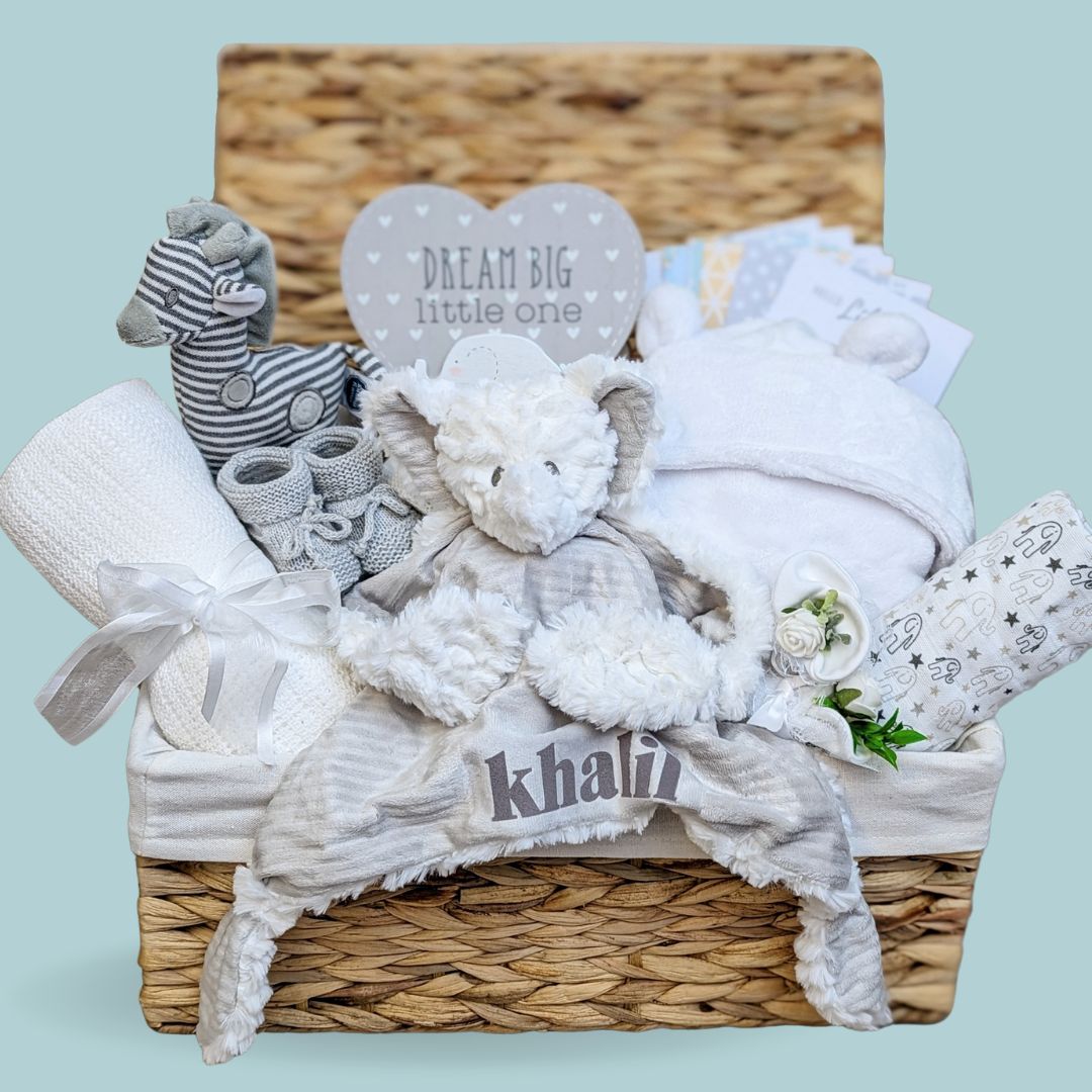 Unisex baby hamper basket with giraffe and elephant theme. Includes bath robe, blanket, personalised soft toy, milestone cards, muslin wrap and more.