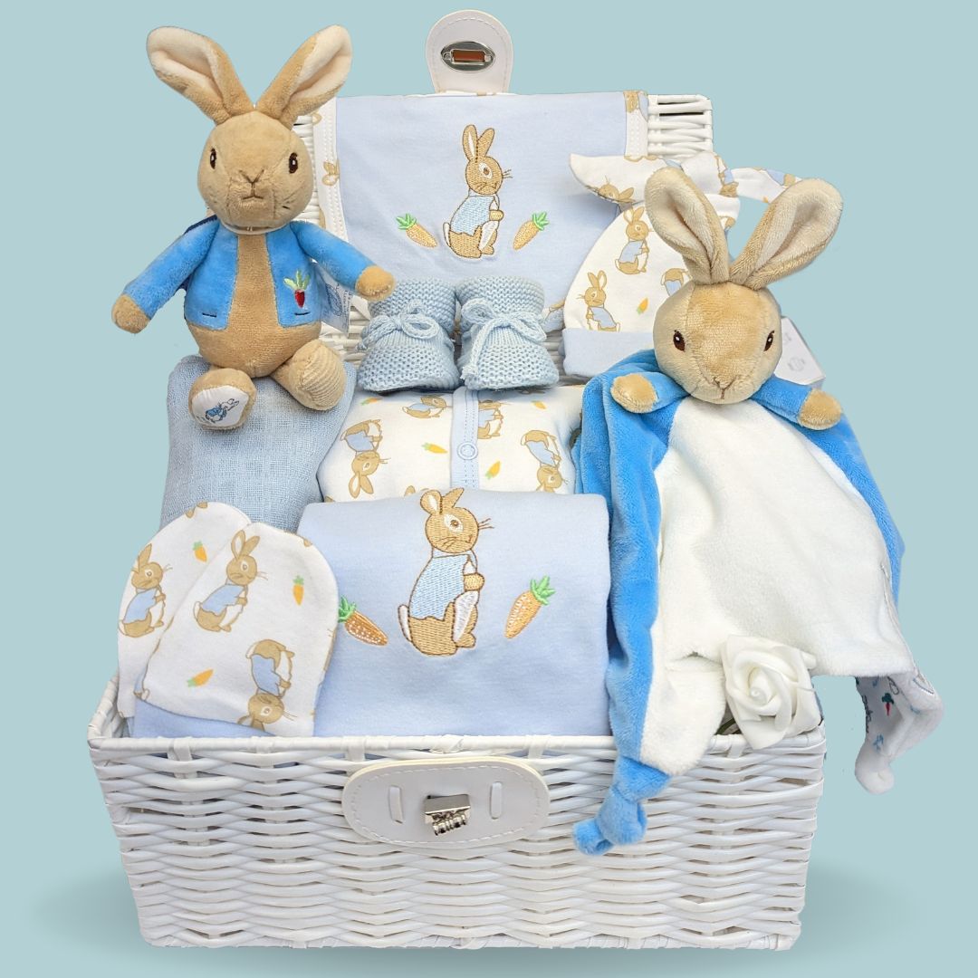 Baby boy hamper with Peter Rabbit theme clothing and baby comforter blanket toy.