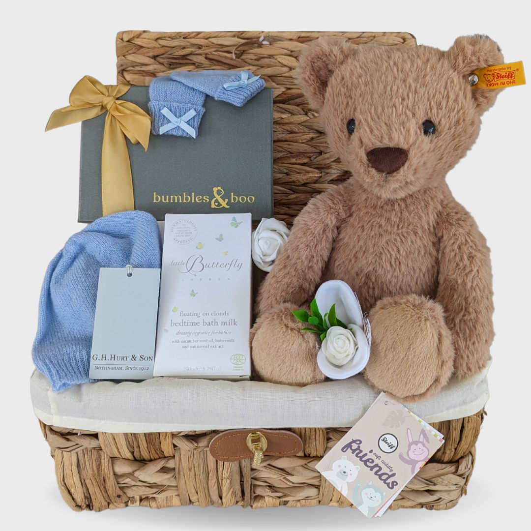 baby boy hamper gifts with steiff teddy, cashmere clothing, chocolates, and organic baby skincare.