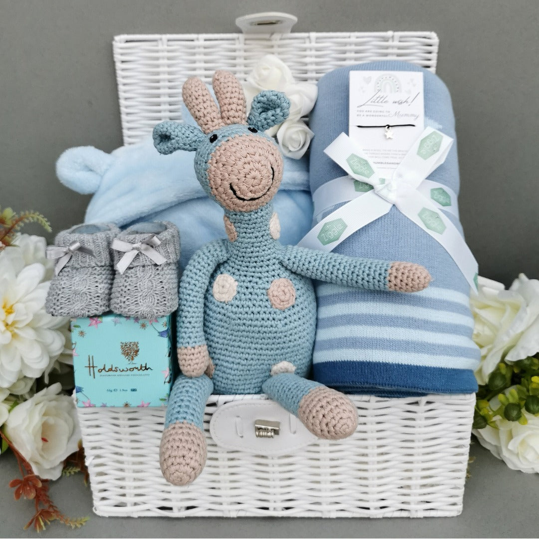 Baby boy hamper with blue blanket and knit giraffe toy