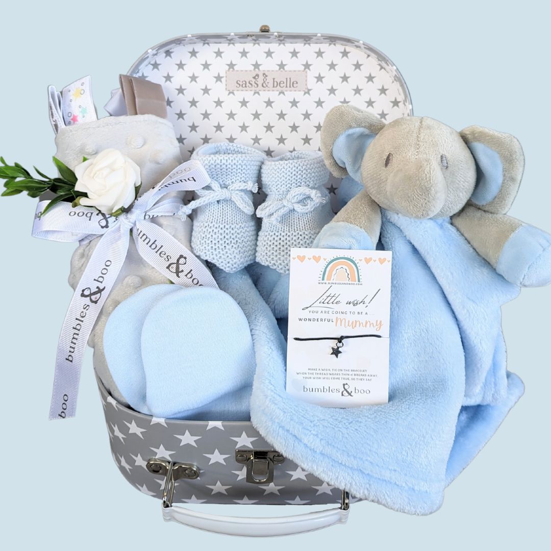 Baby boy hamper keepsake with elephant comforter blanket, taggie blanket, baby booties and scratch mittens. Presented in a luggage suitcase trunk.