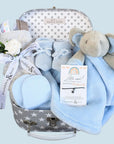 Baby boy hamper keepsake with elephant comforter blanket, taggie blanket, baby booties and scratch mittens. Presented in a luggage suitcase trunk.