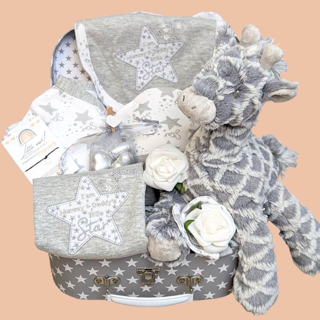 New baby gifts hamper with star baby clothes and grey giraffe.