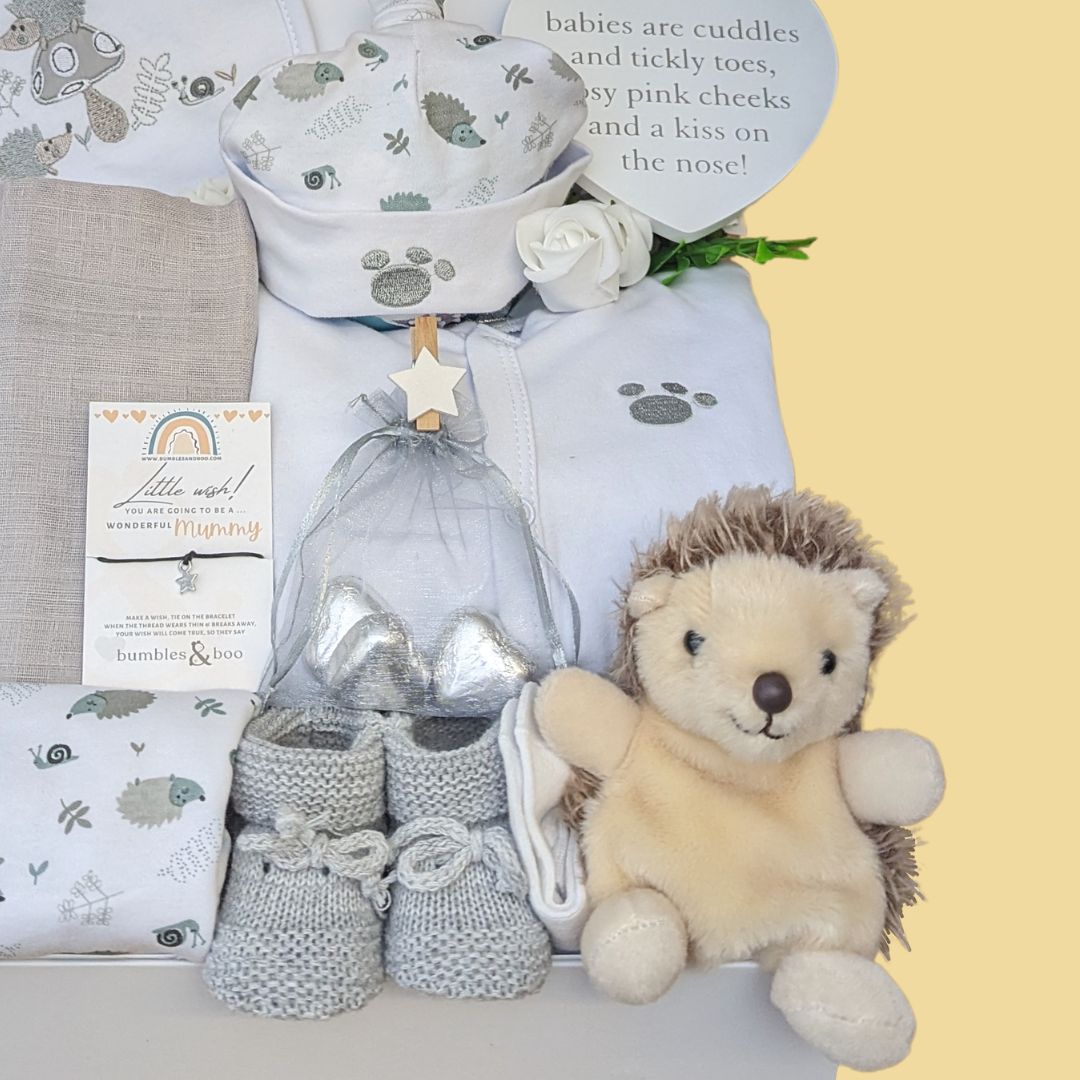 new baby hamper box to include clothing set, giraffe rattle, hanging plaque, muslin wrap, bracelet and chocolates.