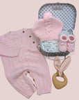 new baby girl hamper gift with romper, hat, booties and bunny teether.