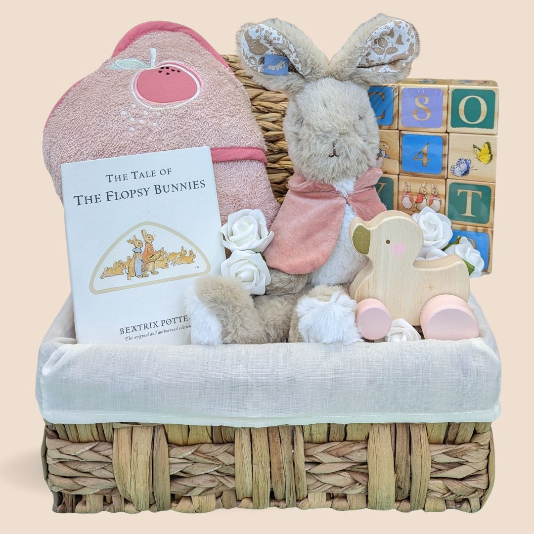 First birthday gift for a baby girl. Includes Flopsy Bunny soft toy, building blocks, hooded organic towel, Flopsy Bunny book and push along wooden toy.
