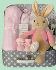 Baby girl hamper basket with blanket, muslin wraps, baby booties and flopsy bunny.