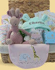 Baby girl hamper gift basket with organic giraffe, bath robe, chocolates, milestone cards.