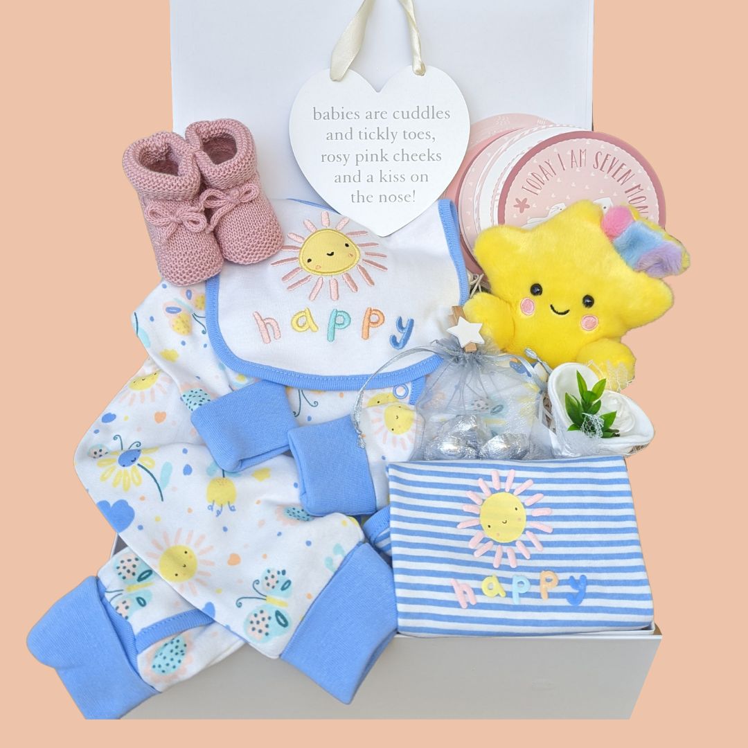 Beautiful baby girl hamper box with organic 'happy' clothing set, baby milestone cards, baby mittens, star soft toy, chocolates for the parents and nursery plaque.