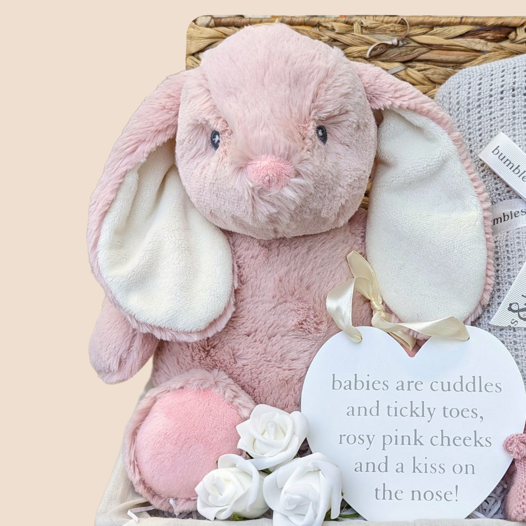 Baby girl hamper gifts with bunny, blanket, muslin wrap and baby booties.